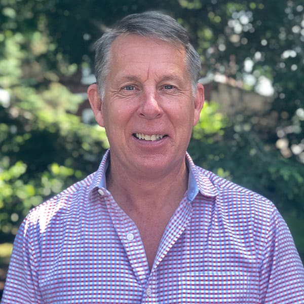 Dan Cressman wearing a checkered blue, white, and red button down shirt standing in front of trees at D.E. Cressman Insurance Agency Inc. in Allentown, PA. Dan Cressman wearing a checkered blue, white, and red button down shirt standing in front of trees at D.E. Cressman Insurance Agency Inc. in Allentown, PA.
